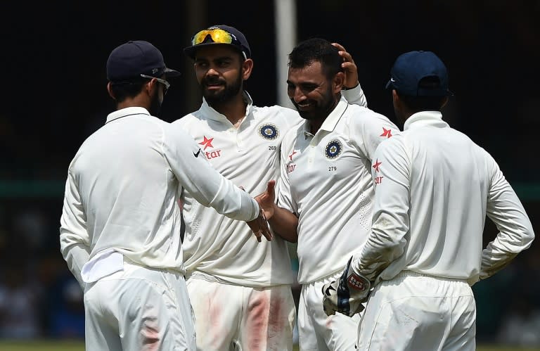 India's Mohammed Shami (2nd R) celebrates the wicket of New Zealand's Mark Craig with captain Virat Kohli (2nd L) and teammates during the fifth day of their first Test match, at Green Park Stadium in Kanpur, on September 26, 2016