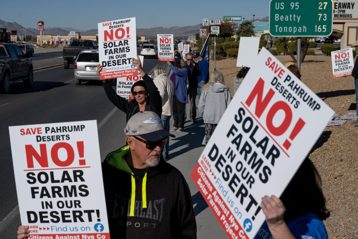 Attendees hold signs at a rally to protest solar development in Pahrump, Nev., on Nov. 27, 2021. (Bridget Bennett for NBC News)