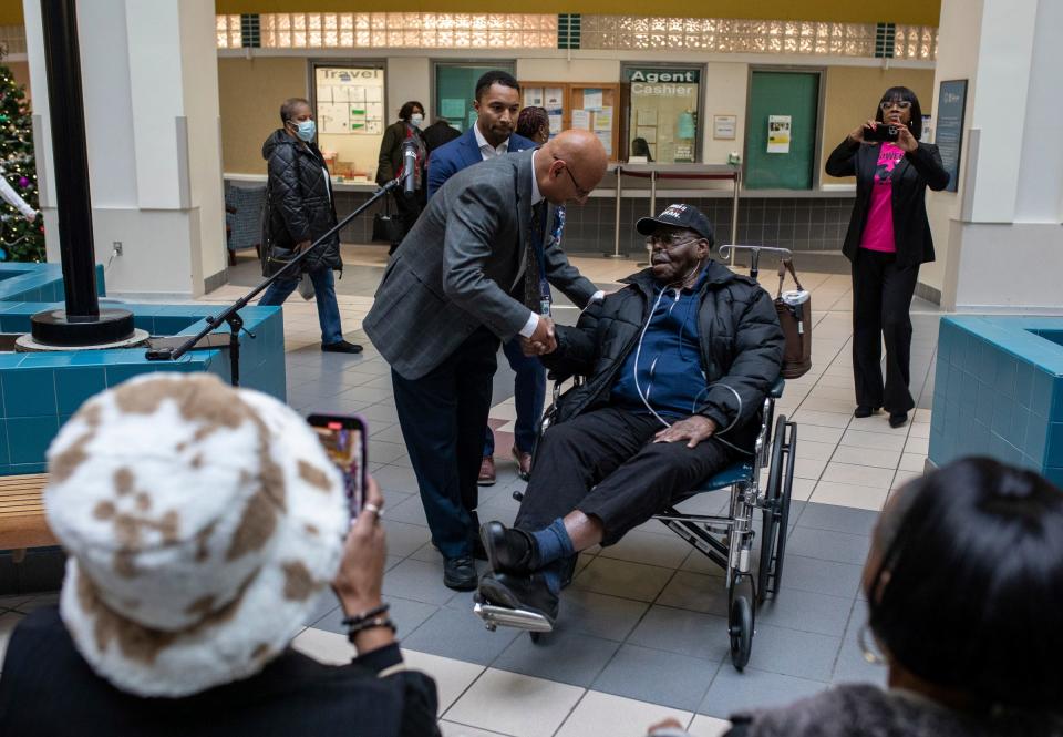 Dr. Raghu Matta, Chief of Staff of the John D. Dingell VA Medical Center, shakes the hand of World War II Veteran Early Jones inside John D. Dingell VA Medical Center in Detroit on Thursday, Dec. 7, 2023.