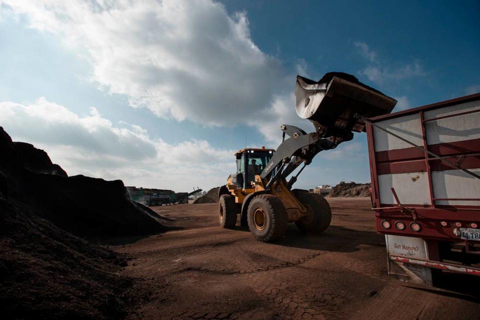 A worker loads finished compost at the City of Modesto Compost Facility west of Modesto, Calif., on Wednesday, Nov. 17, 2021.