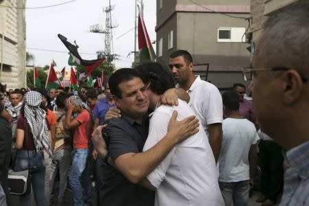 Head of the Joint Arab List, Ayman Odeh (C) greets a man during a pro-Palestinian demonstration in the northern Israeli town of Sakhnin October 13, 2015. REUTERS/Baz Ratner