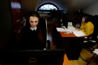 Town hall clerk Monika Pawlik, 24, works at her office in City Hall in Ostrow Mazowiecka, Poland, January 16, 2018. REUTERS/Kacper Pempel/Files