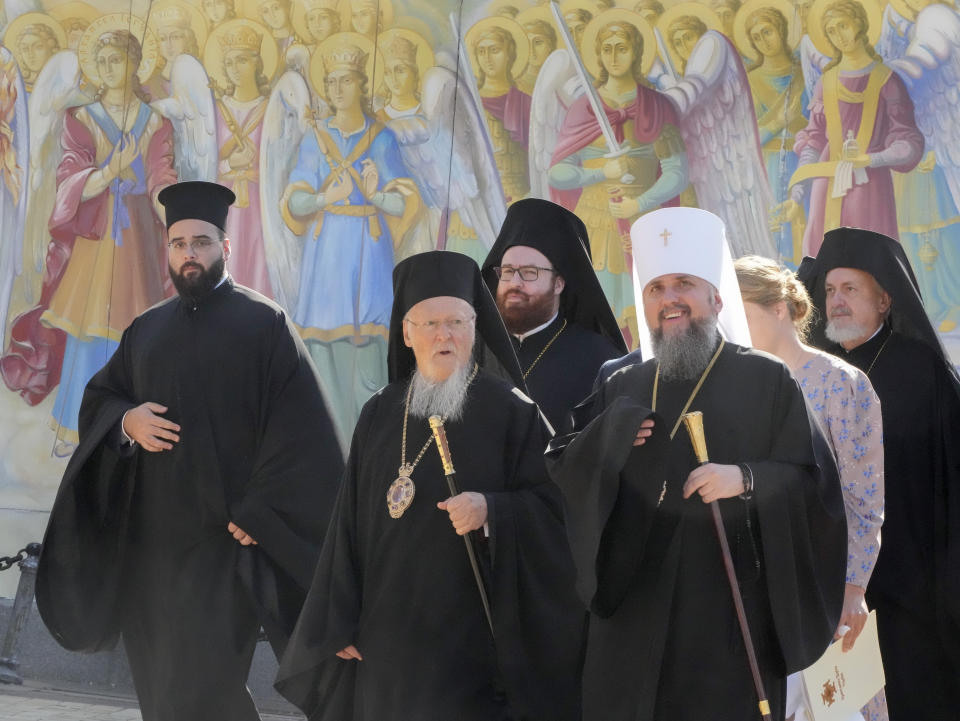 Ecumenical Patriarch Bartholomew I, center, accompanied by the Head of the Ukrainian Church Metropolitan Epiphanius, right, visits the Mikhailovsky Zlatoverkhy Cathedral (St. Michael's Golden-Domed Cathedral) in Kyiv, Ukraine, Saturday, Aug. 21, 2021. Bartholomew I, arrived to Kyiv to mark the 30th anniversary of Ukraine's independence that is celebrated on Aug. 24. (AP Photo/Efrem Lukatsky)