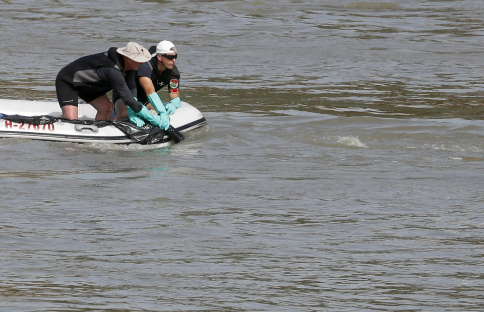 A victim's body is lifted by the rescue workers on the Danube river where a sightseeing boat capsized in Budapest, Hungary, Wednesday, June 5, 2019. Divers and rescue crews slowly are recovering the bodies of a growing number of people killed when a sightseeing boat and a long river cruise ship collided in Hungary's capital. (AP Photo/Laszlo Balogh)