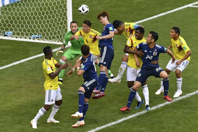 Yuya Osako (centre) heads Japan's winner against Colombia in World Cup Group H