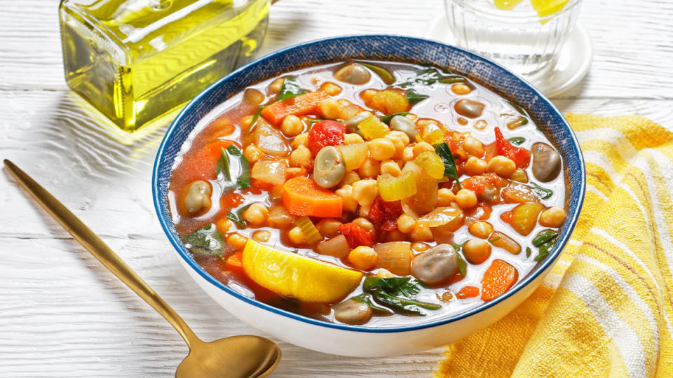 Bowl of soup with white beans, tomatoes and vegetables made with olive oil for weight loss