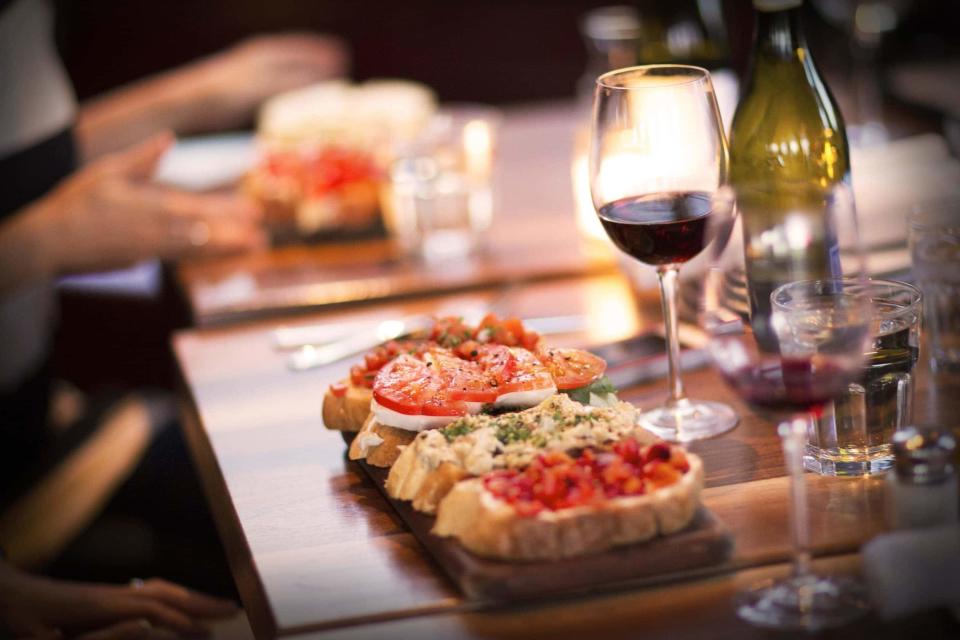 Postino Wine Cafe's bruschetta paired with a glass of wine is a perfect happy hour treat.