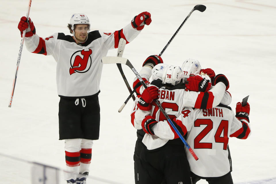 New Jersey Devils players celebrate a goal by defenseman Ty Smith (24) during the second period of an NHL hockey game against the Buffalo Sabres, Saturday, Jan. 30, 2021, in Buffalo, N.Y. (AP Photo/Jeffrey T. Barnes)
