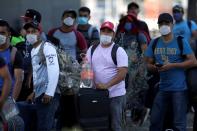 FILE PHOTO: Migrants seeking for a U.S. work visa after being evicted from hotel, which local authorities said was crowded, as part of the measures to prevent the spreading of the coronavirus disease COVID-19, in Monterrey