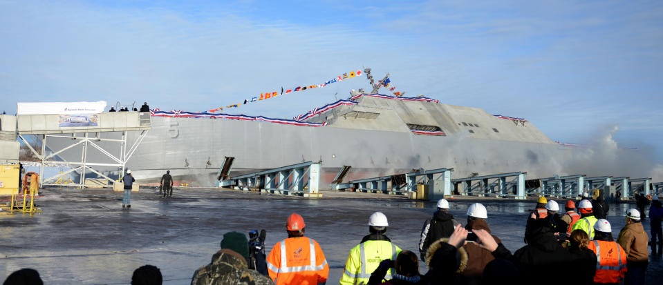 FILE - In this Dec. 18, 2013 file photo, the future USS Milwaukee hits the water during the christening ceremony at Marinette Marine Corporation, in Marinette, Wis. Defense Secretary Chuck Hagel’s vision for leaner, more versatile military targeted the littoral combat ship, the marquee product of the city’s biggest employer. And that could mean lost jobs in Marinette, a city of roughly 11,000. (AP Photo/Green Bay Press-Gazette, H. Marc Larson, File)