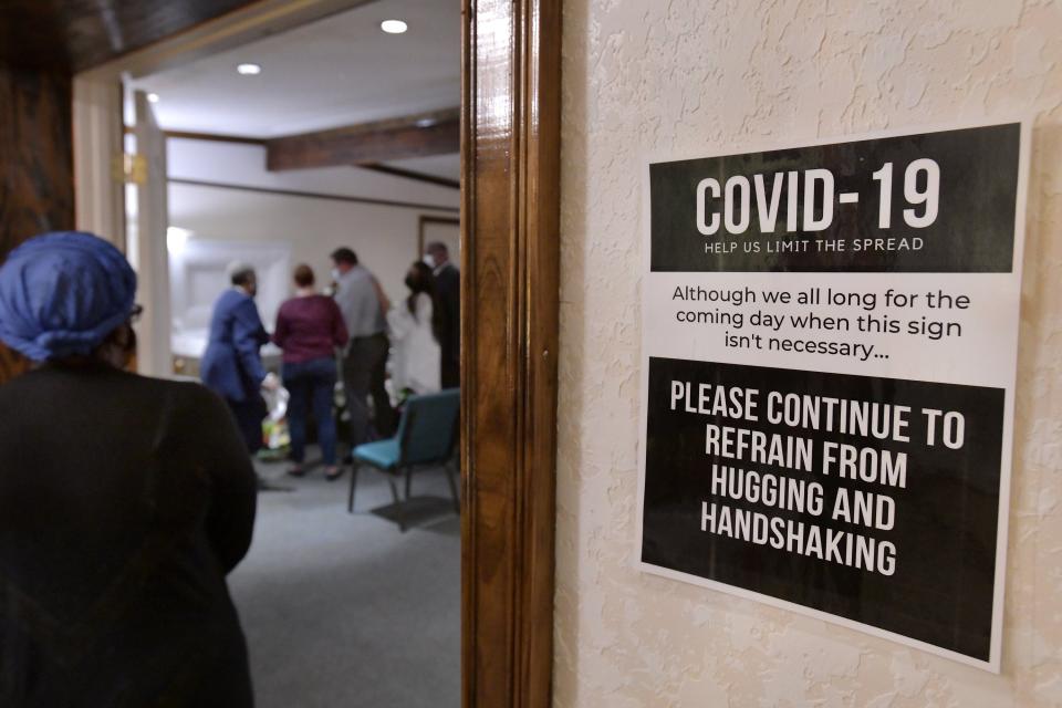 Signage reminds visitors to take precautions because of COVID-19 at the James Graham Mortuary on Moncrief Road in Jacksonville, Florida Friday, August 20, 2021.