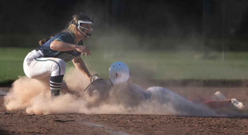 Indianapolis Cathedral High School sophomore Angie Valentine (3) makes a tag on a Lawrence North High School base runner during a IHSAA Class 4A Softball Sectional Championship game, Friday, May 26, 2023, at North Central High School.