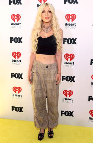 <p>Jesse Grant/Getty</p> Tori Spelling attends the 2024 iHeartRadio Music Awards at Dolby Theatre in Los Angeles, California on April 1, 2024.