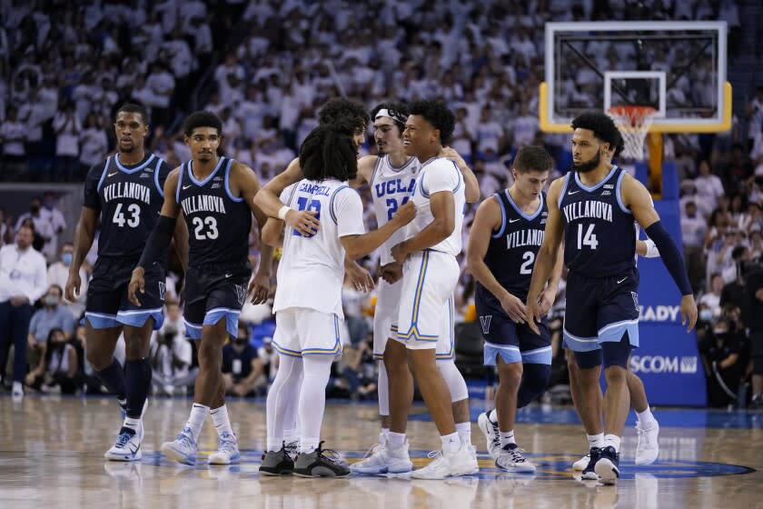 UCLA players huddle in the closing seconds Friday's overtime victory over Villanova.