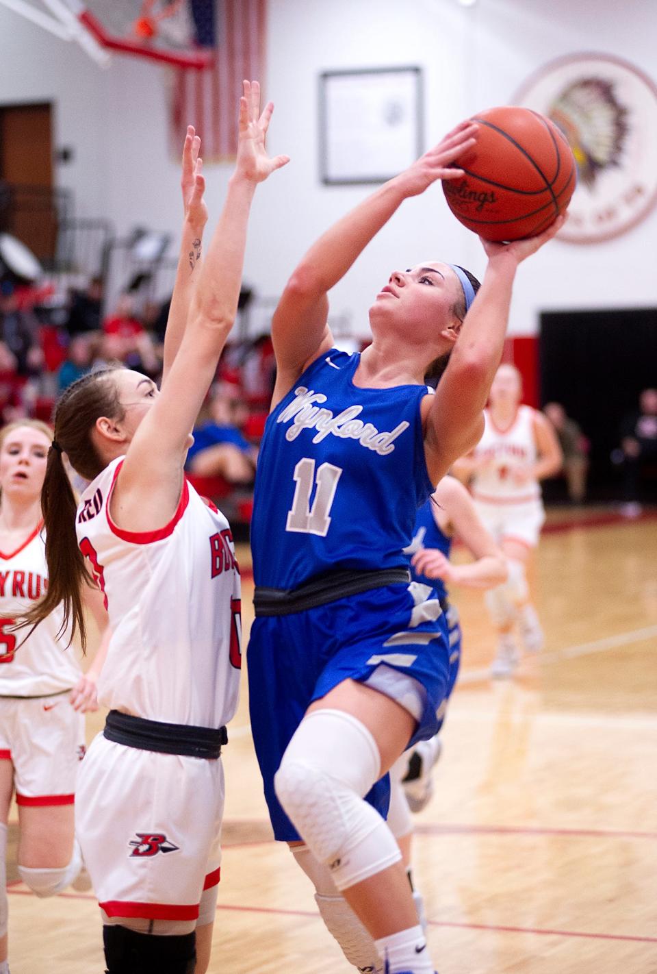 Wynford's Reese McGuire shoots over Bucyrus' Brook Dennison.