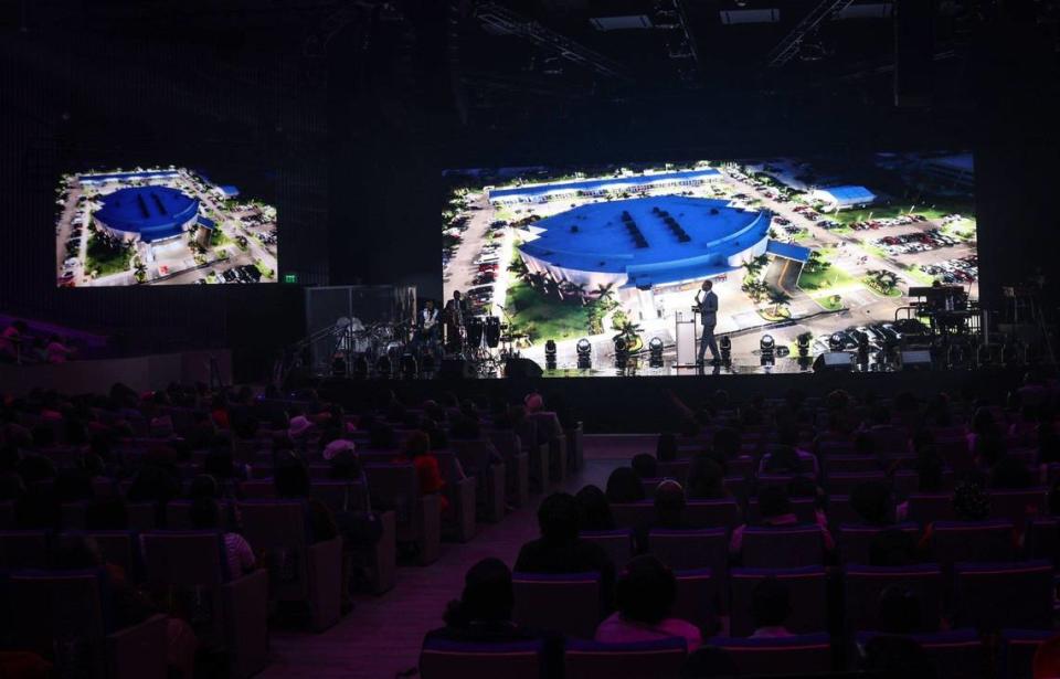 Pastor Gregory Toussaint of Tabernacle of Glory, center, walks back on stage during the end of the video presentation about the new $60 million campus in North Miami-Dade County.