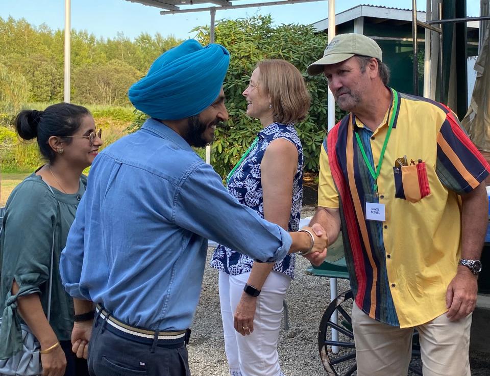 Captain Pradeep Singh Sethi, Indian Navy, shakes hands with David Scovel while his wife Amandeep pay respects to Rear Admiral Shoshana Chatfield, Naval War College President.