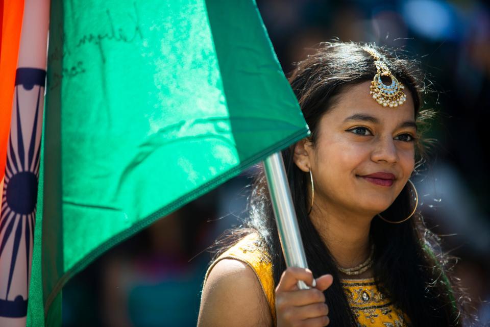 Avani Prasad walks down the street with the Indian delegation as part of the Parade of Cultures during the International Food and Art Festival on Saturday, October 1, 2022, in Jackson, Tenn. 