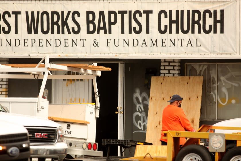 EL MONTE, CA - JANUARY 23, 2021 - A worker cleans up the scene where authorities are investigating vandalism and an explosion that occurred today at the First Works Baptist Church in El Monte on January 23, 2021. "The FBI responded overnight with the El Monte Police Department to an IED attack at the First Works Baptist Church,'' FBI spokeswoman Laura Eimiller said. "FBI bomb technicians and an evidence response team are processing the scene which sustained damage.'' No injuries were reported, Eimiller said, adding, "A joint investigation is underway for the person or group responsible for the attack.'' The church, headed by Pastor Bruce Mejia, has been the focus of community protests in recent weeks due to what are perceived to be teachings against the LGBTQ community. (Genaro Molina / Los Angeles Times)