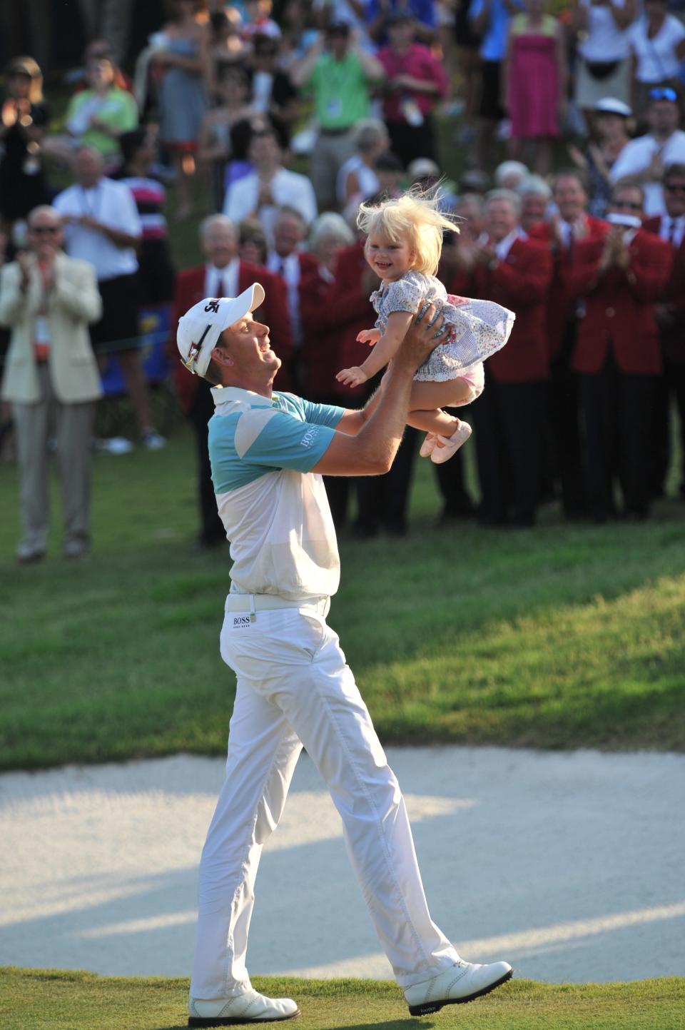 Henrik Stenson tosses his daughter Lisa in the air after winning the 2009 Players Championship.