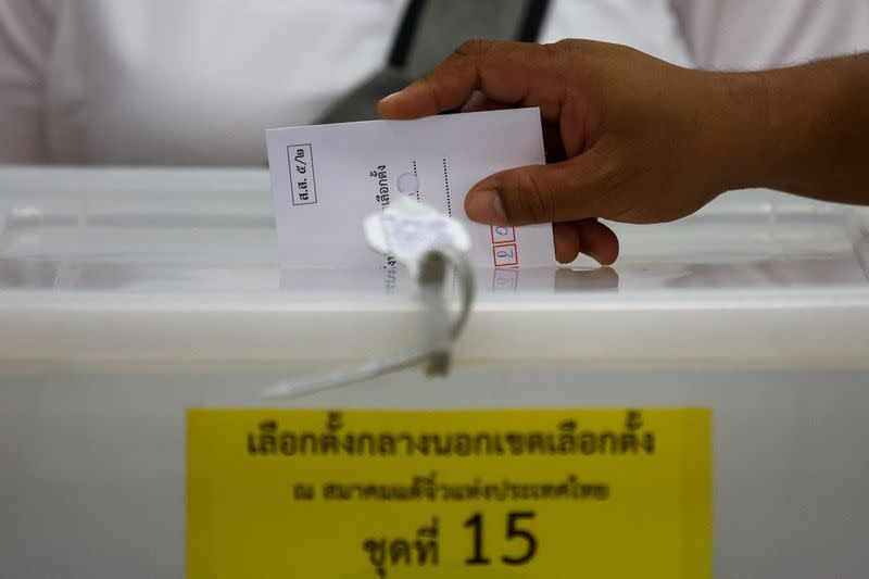 A man casts his early vote for the upcoming Thai general election at a polling station in Bangkok