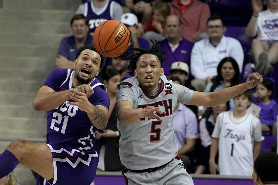 TCU forward JaKobe Coles (21) and Texas Tech guard Darrion Williams (5) compete for a loose ball in the first half of an NCAA college basketball game in Fort Worth, Texas, Tuesday, Jan. 30, 2024. (AP Photo/Tony Gutierrez)