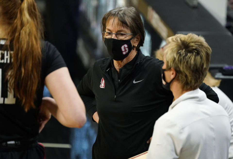 Stanford head coach Tara VanDerveer confers with players in a timeout late in overtime of an NCAA college basketball game against Colorado, Sunday, Jan. 17, 2021, in Boulder, Colo. (AP Photo/David Zalubowski)