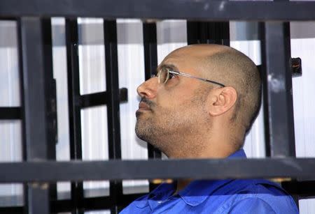 Saif al-Islam Gaddafi, son of late Libyan leader Muammar Gaddafi, attends a hearing behind bars in a courtroom in Zintan May 25, 2014. REUTERS/Stringer