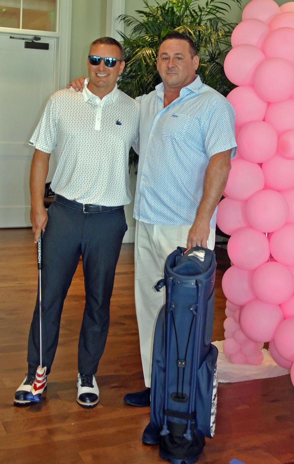 Sawgrass Country Club director of golf Stefan Brunt (left) and assistant general manager Perry Kenny modeled fashions from the club's golf shop at the Sawgrass Women's Club annual luncheon and fashion show.