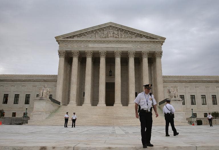 Police patrol in front of the US Supreme Court in Washington, DC on June 30, 2014