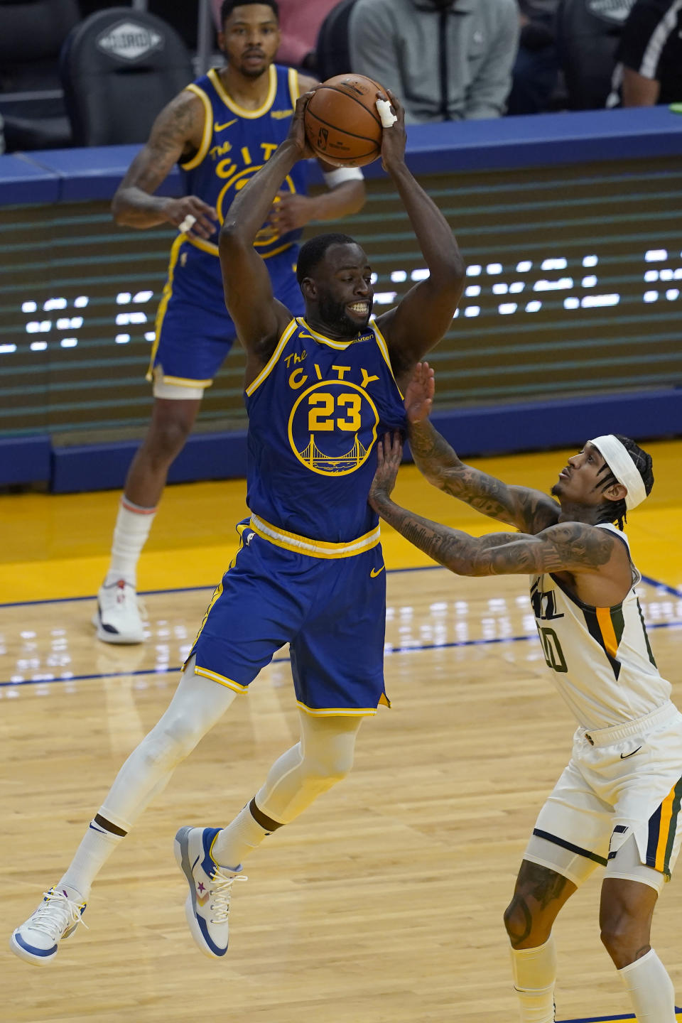 Golden State Warriors forward Draymond Green, center, is defended by Utah Jazz guard Jordan Clarkson, right, during the first half of an NBA basketball game in San Francisco, Monday, May 10, 2021. (AP Photo/Jeff Chiu)