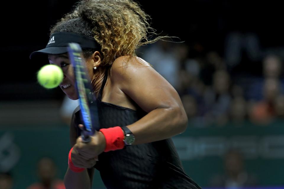 Naomi Osaka of Japan returns a shot to Sloane Stephens of the United States during their women's singles match at the WTA tennis tournament in Singapore on Monday, Oct. 22, 2018. (AP Photo/Vincent Thian)