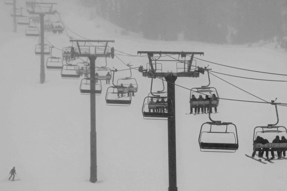 In this photo provided by Mammoth Mountain Ski Area skiers ride a lift during a snowfall at Mammoth Mountain Ski Area in Mammoth Lakes, Calif., on Saturday, Jan. 13, 2024. As the three-day Martin Luther King Jr. Day holiday weekend began, the weather forecast was a crazy quilt of color-coded advisories, from an ice storm warning in Oregon to a blizzard warning in the northern Plains to high wind warnings in New Mexico. (Peter Morning/Mammoth Mountain Ski Area via AP
