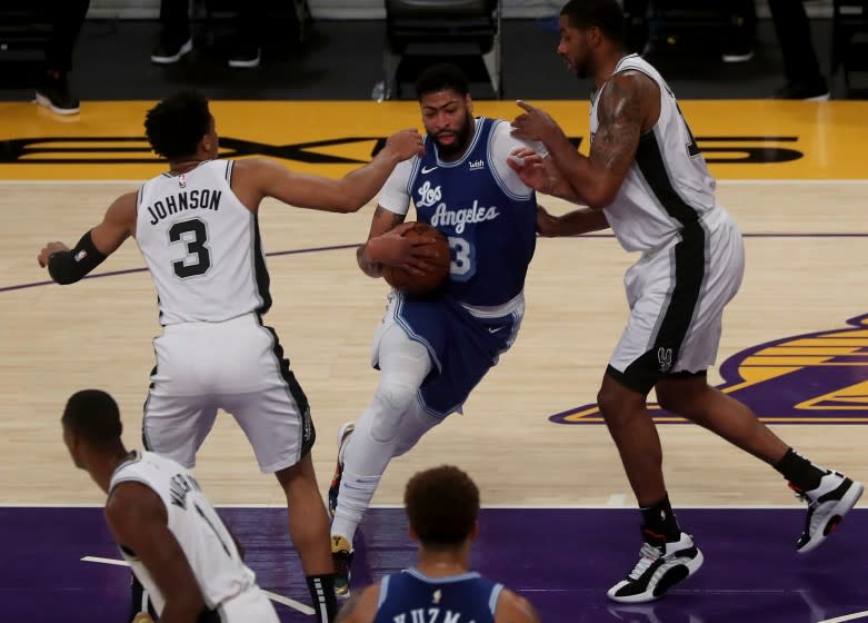 LOS ANGELES, CA. - JAN. 7, 2021. Lakers big man Anthony Davis splits the defense of the Spurs in the first quarter on Thursday night, Jan. 7, 2021, at Staples Center in Los Angeles. (Luis Sinco/Los Angeles Times)