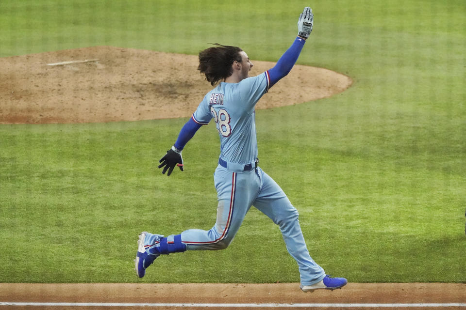 Texas Rangers designated hitter Jonah Heim celebrates as he heads to home plate after hitting the game-winning home run in the ninth inning of a baseball game against the Seattle Mariners Sunday, Aug.1, 2021, in Arlington, Texas. (AP Photo/Louis DeLuca)