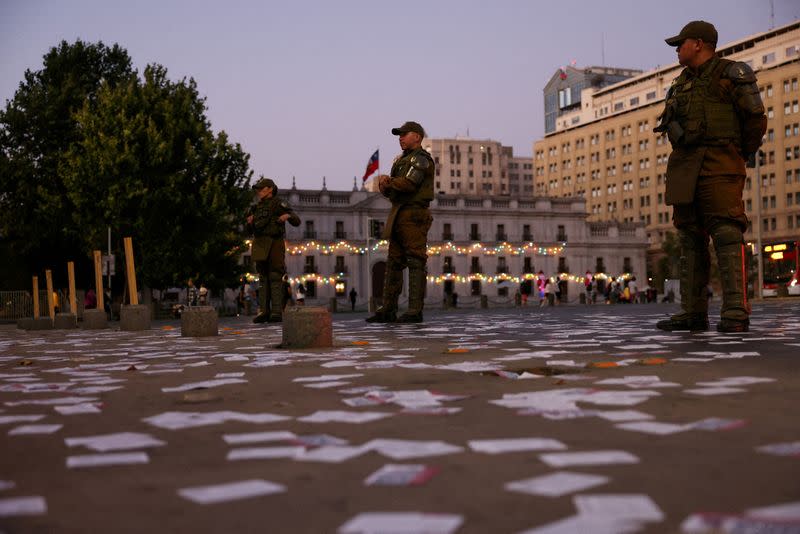 FILE PHOTO: Police officers stand watch after polls closed, on the day of the referendum on a new Chilean constitution in Santiago, Chile, December 17, 2023. REUTERS/Ivan Alvarado/