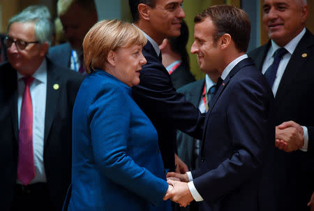 FILE PHOTO: German Chancellor Angela Merkel and French President Emmanuel Macron attend the European Union leaders summit in Brussels, Belgium October 17, 2018. REUTERS/Toby Melville/File Photo