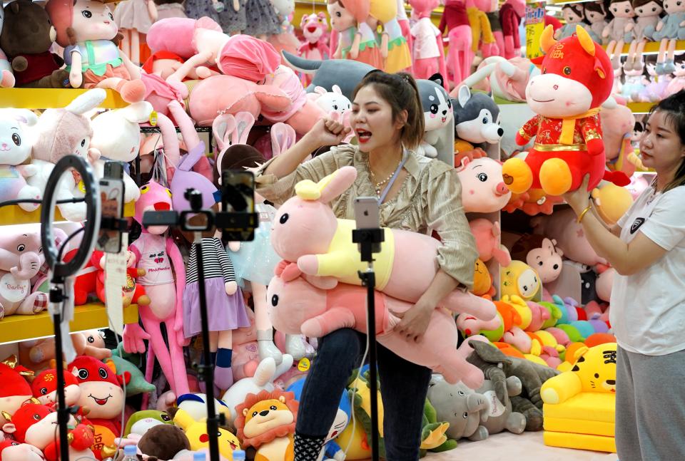 BAODING, Feb. 2, 2021 -- Saleswomen promote stuffed toys via livestreaming at an international trading center in Baigou New Township, Baoding City of north China's Hebei Province, Feb. 2, 2021. Traders in the Baigou New Township have launched an on-line shopping event for the upcoming Chinese Lunar New Year, where price discounts, electronic coupons, and purchase subsidies are offered to attract more buyers for their commodities such as suitcases, garments, and stuffed toys. (Photo by Feng Yun/Xinhua via Getty) (Xinhua/Feng Yun via Getty Images)