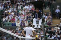 Greece's Stefanos Tsitsipas speaks with an official during his third round men's singles match against Australia's Nick Kyrgios on day six of the Wimbledon tennis championships in London, Saturday, July 2, 2022. (AP Photo/Kirsty Wigglesworth)