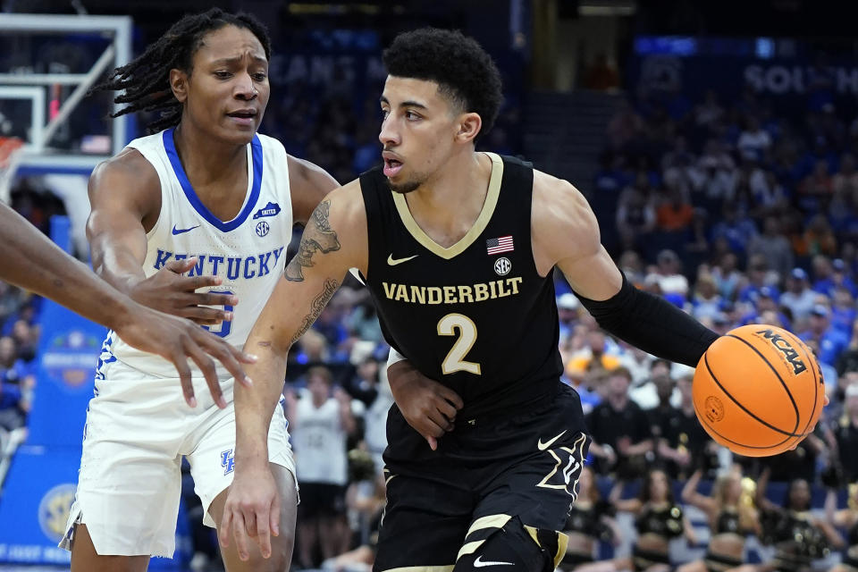 Vanderbilt guard Scotty Pippen Jr. (2) drives around Kentucky guard TyTy Washington Jr. (3) during the first half of an NCAA college basketball game in the Southeastern Conference men's tournament Friday, March 11, 2022, in Tampa, Fla. (AP Photo/Chris O'Meara)