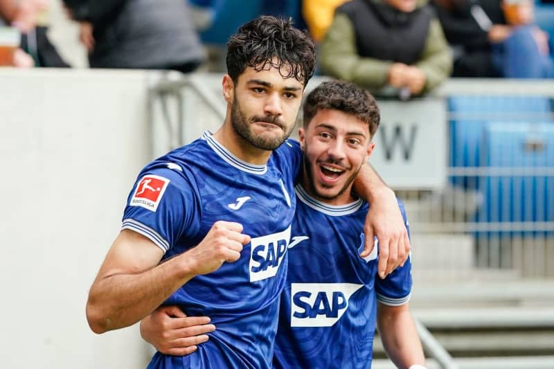 Hoffenheim's Ozan Kabak (L) celebrates scoring his side's third goal with teammate Umut Tohumcu during the German Bundesliga soccer match between TSG 1899 Hoffenheim and Borussia Monchengladbach at PreZero Arena. Uwe Anspach/dpa