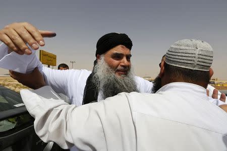 Radical Muslim cleric Abu Qatada (L) hugs his family members after his release from a prison near Amman September 24, 2014. REUTERS/Muhammad Hamed