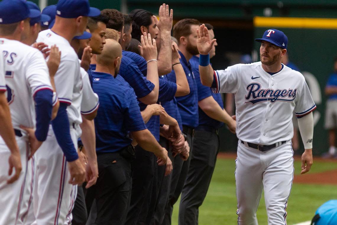 Rangers pitcher Jacob deGrom high-fives his new teammates during Rangers Opening Day ceremonies on March 30, 2023, at Globe Life Field in Arlington. The Texas Rangers beat the Philadelphia Phillies 11-7.