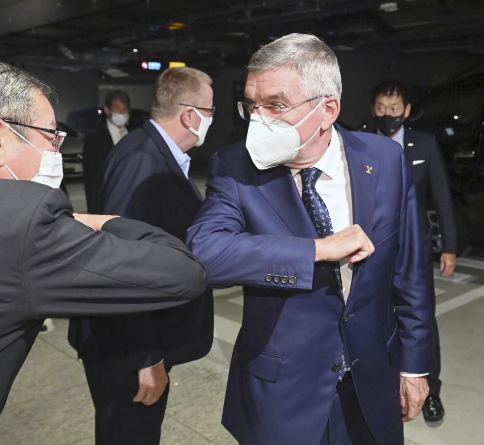 International Olympic Committee President Thomas Bach arrives at a hotel in Tokyo Sunday, Nov. 15, 2020. IOC President Bach is beginning a visit to Tokyo to convince politicians and the Japanese public that the postponed Olympics will open in just over eight months.(Kyodo News via AP)