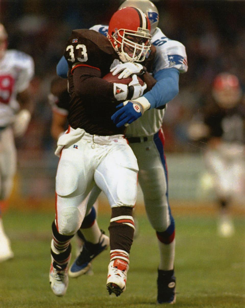 Browns running back Leroy Hoard (33) drags a Patriots defender in 1994. [Beacon Journal/Ohio.com file photo]