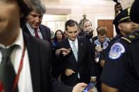 U.S. Senator Ted Cruz (R-TX) is flanked by reporters and police as he departs after a Republican Senate caucus meeting at the U.S. Capitol in Washington, October 16, 2013. REUTERS/Jonathan Ernst