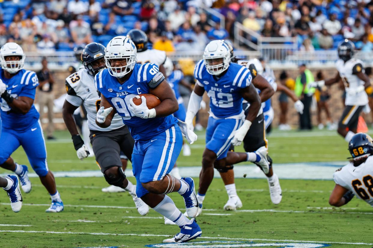 Duke's DeWayne Carter scores a touchdown after a fumble recovery in 2022. The Pickerington Central graduate was drafted by the Buffalo Bills on Friday.