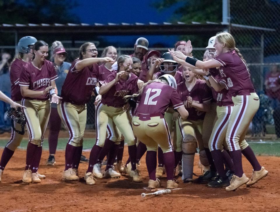 Chiefs surround the plate to greet Kayla Dixon (12) as she comes home on a 2-run homer cutting the Royals lead to 6-3 in the top of the 7th inning during the Northview vs Jay 1A regional semifinal playoff softball game at Jay High School on Thursday, May 12, 2022.