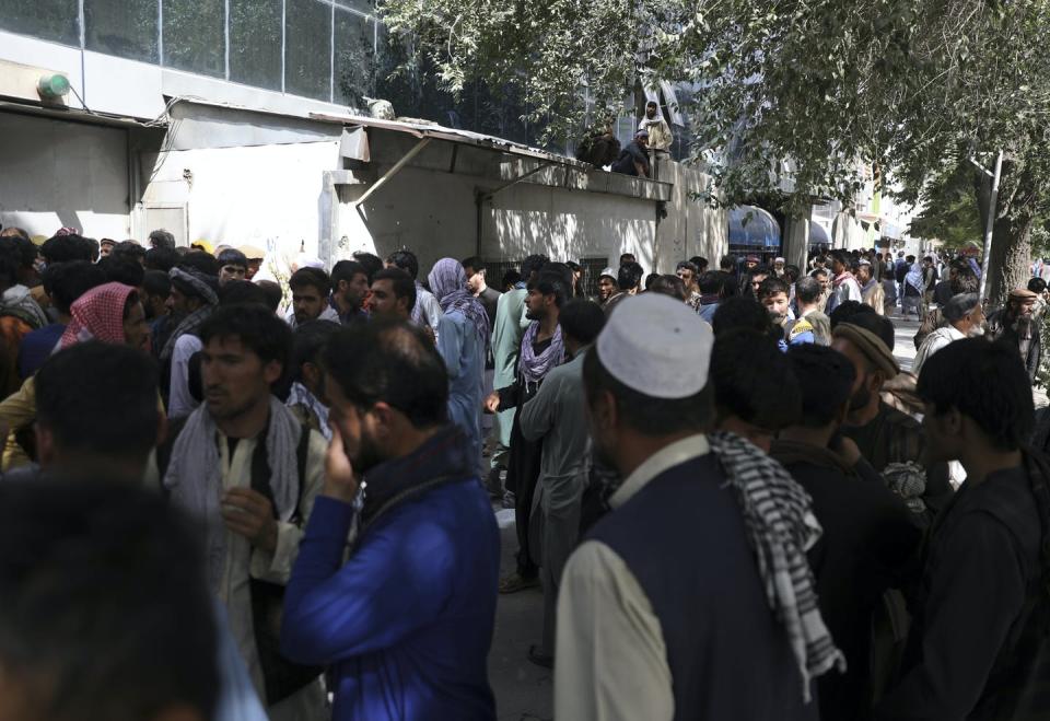 Crowds of Afghans trying to take money out of the bank in Kabul.