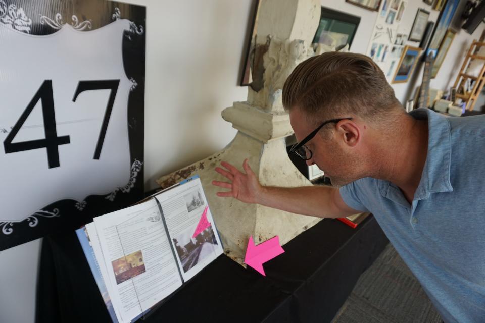 First Baptist Church Pastor Doug Hankins examines artifacts and history of the church.